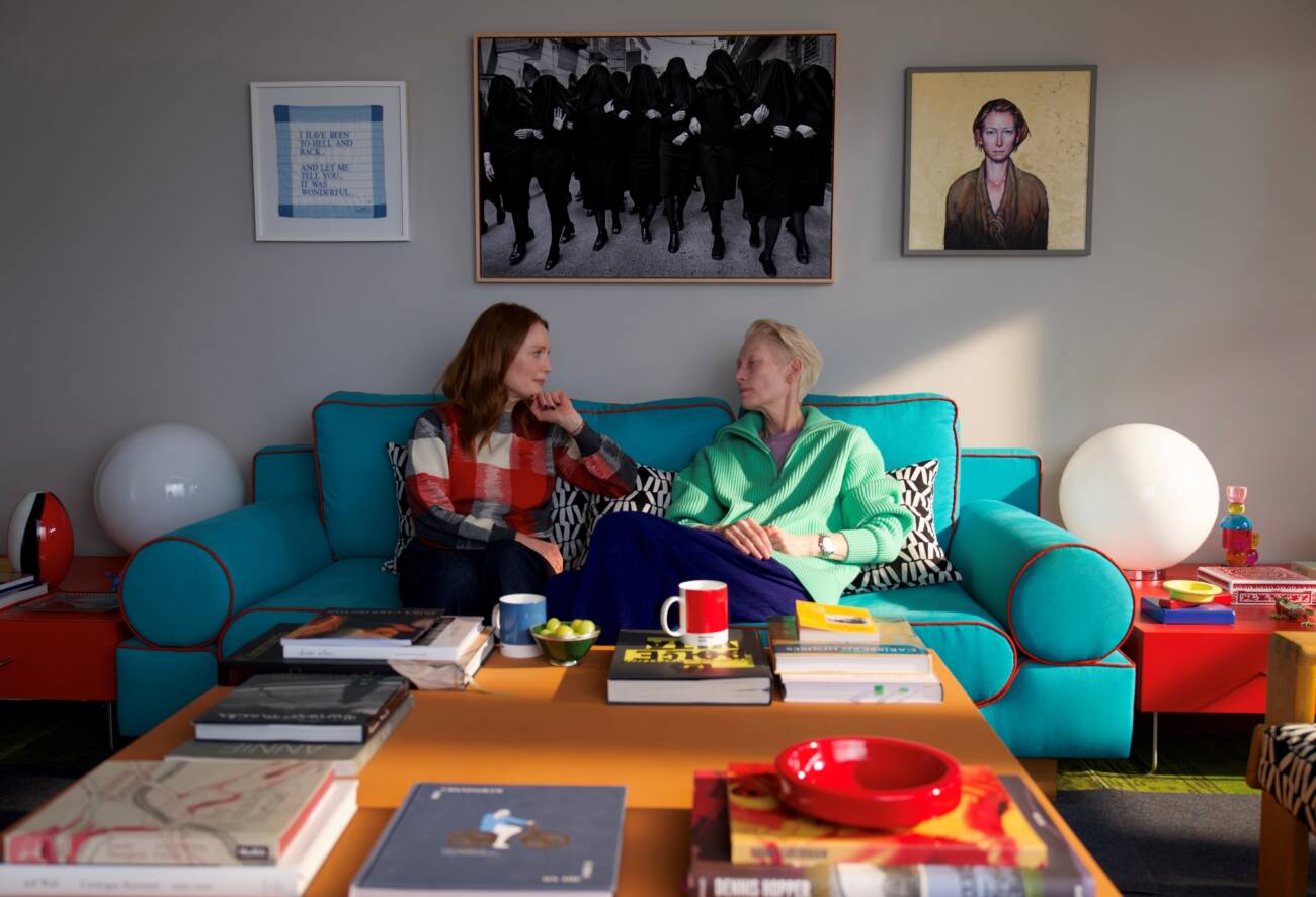 Duas mulheres conversando em sala colorida e moderna.