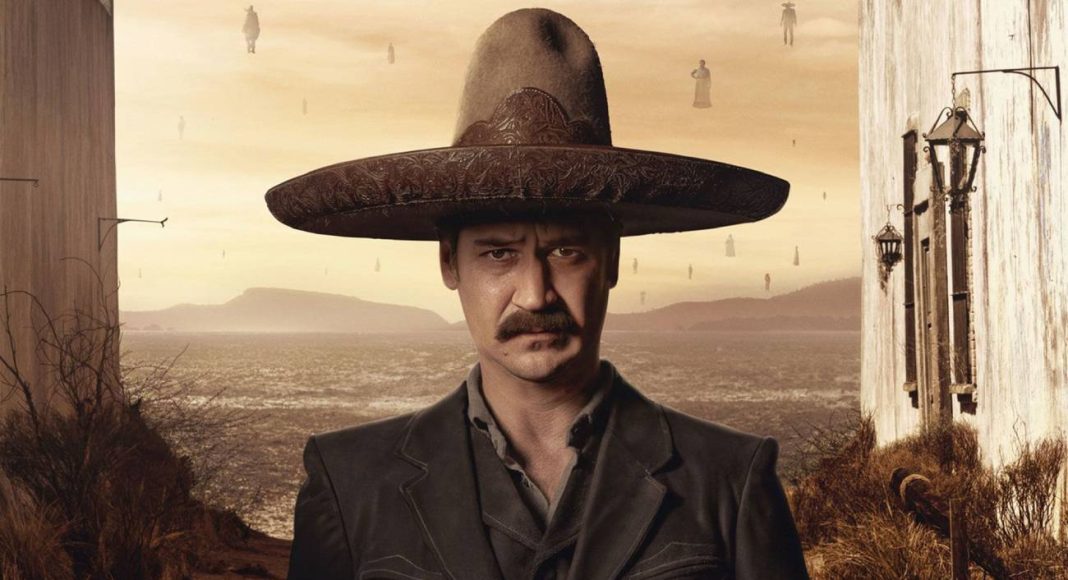 Homem com sombrero, deserto ao fundo.