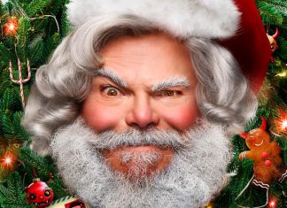 Papai Noel cercado por decoração natalina festiva.