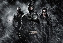 Batman, Batgirl e Bane sob chuva intensa e escombros