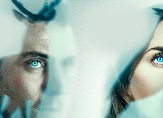 Two people gaze through a frosted, bluish glass, their blue eyes visible.