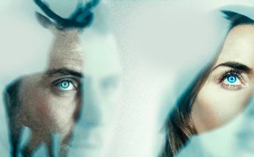 Two people gaze through a frosted, bluish glass, their blue eyes visible.