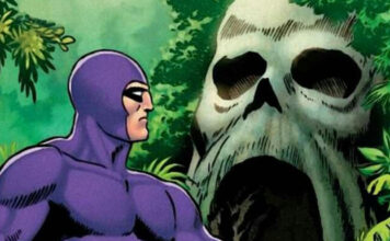 Purple-costumed superhero stands in a jungle, facing a massive skull-shaped rock opening.