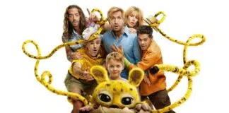 Child and several adults surround a yellow, big-eyed creature peeking from a cracked eggshell, tangled in yellow ropes, on a white background.