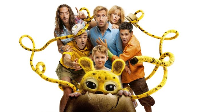 Child and several adults surround a yellow, big-eyed creature peeking from a cracked eggshell, tangled in yellow ropes, on a white background.