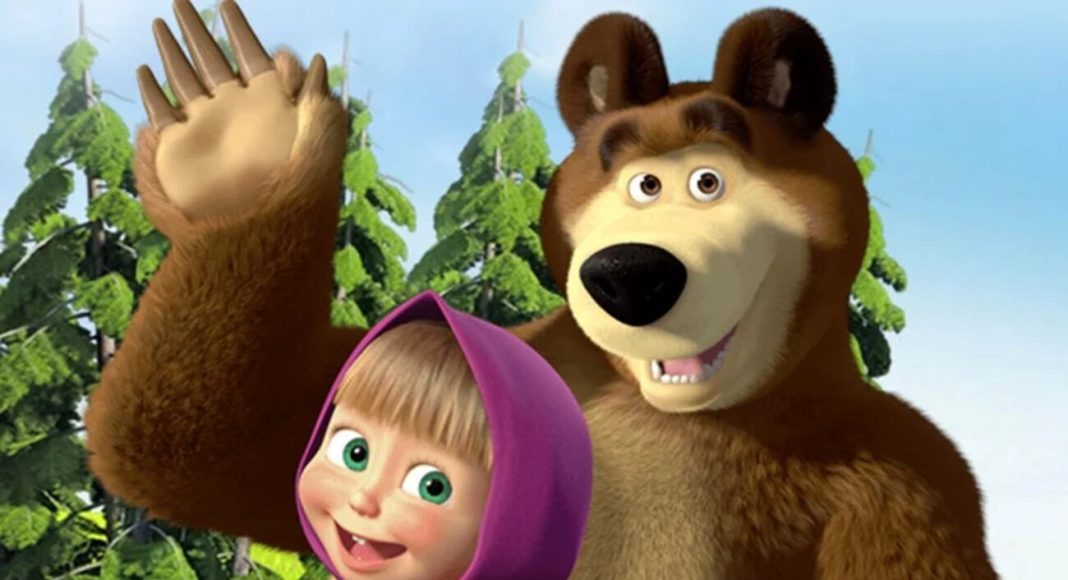 Masha e o Urso (1) Brown bear and a smiling girl in a purple hood wave hello together in a bright forest setting