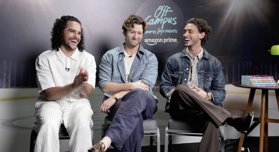 Off Campus Three men sit on stools in a studio, laughing during a talk show with an 'Off Campus' backdrop and Amazon Prime logo in the background.