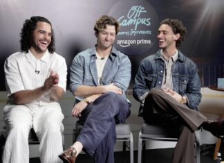 Three men sit on stools in a studio, laughing during a talk show with an 'Off Campus' backdrop and Amazon Prime logo in the background.