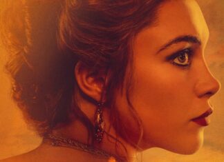 Florence Pugh estrela a minissérie de época ‘A Leste do Éden’, da Netflix; Confira o trailer! Close-up profile of a woman with an elegant updo, wearing a necklace and dangling earring, bathed in warm amber light.