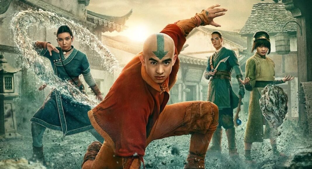Dynamic fantasy battle scene with four martial artists; central bald hero with arrow on his head leaps forward as debris and water swirl around them in a village square.