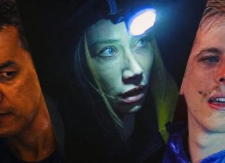 Three close-up faces in dramatic lighting: a man on the left, a woman with a headlamp in the center, and a man on the right, all looking in different directions.