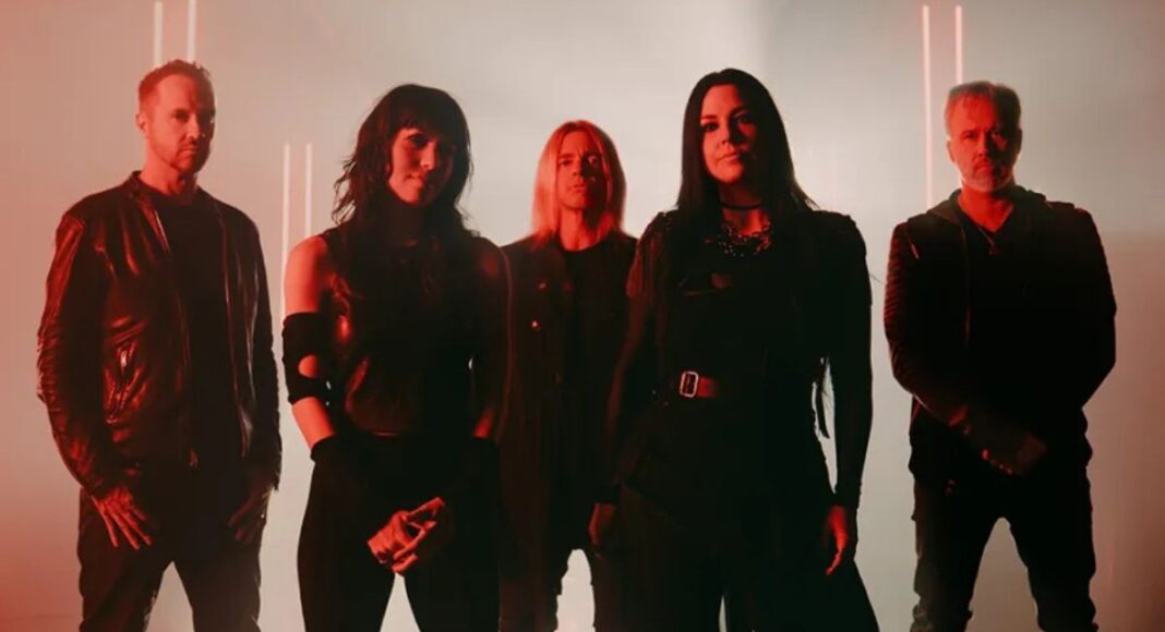 evanescence 3 A five-member rock band posing in a dimly lit studio with red lighting and edgy outfits, facing the camera confidently.