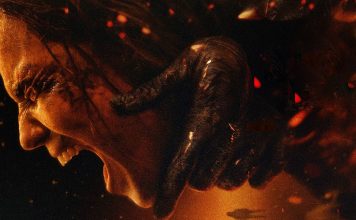 Side profile of a woman screaming as a dark, clawed hand clamps her neck in a fiery, hellish scene.