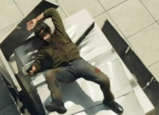 ‘O Justiceiro: Uma Última Morte’: Fontes revelam que cena do CGI “inacabado” foi gravada de forma prática Man lying on an indoor staircase, appearing injured, with a hand on his head and blood on his knee area.