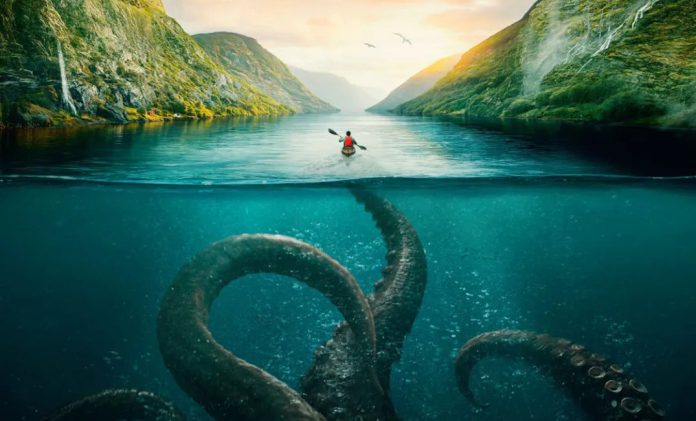 Kayaker paddling on a river between green mountains, with giant tentacles visible beneath the turquoise water.