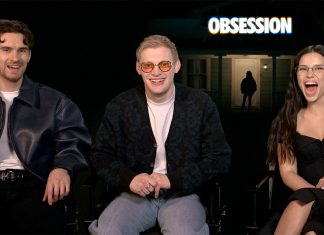 Three people sit and smile on a talk-show set; a glowing OBSESSION sign is behind them.