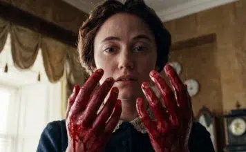 Woman with blood-stained hands held up near her face in a tense moment indoors, no visible injuries shown clearly on her face.