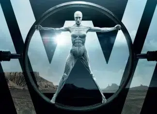‘Westworld’ ganhará novo REMAKE com roteirista de ‘Jurassic Park’ Futuristic humanoid figure with exposed muscles stands inside a circular portal, desert canyon behind with bold geometric 'W' shapes.