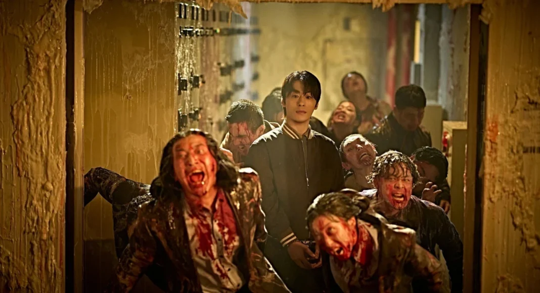 zona zero3 Young man in a black jacket stands calmly in a dim, blood-splattered hallway as snarling, zombified figures swarm around him.