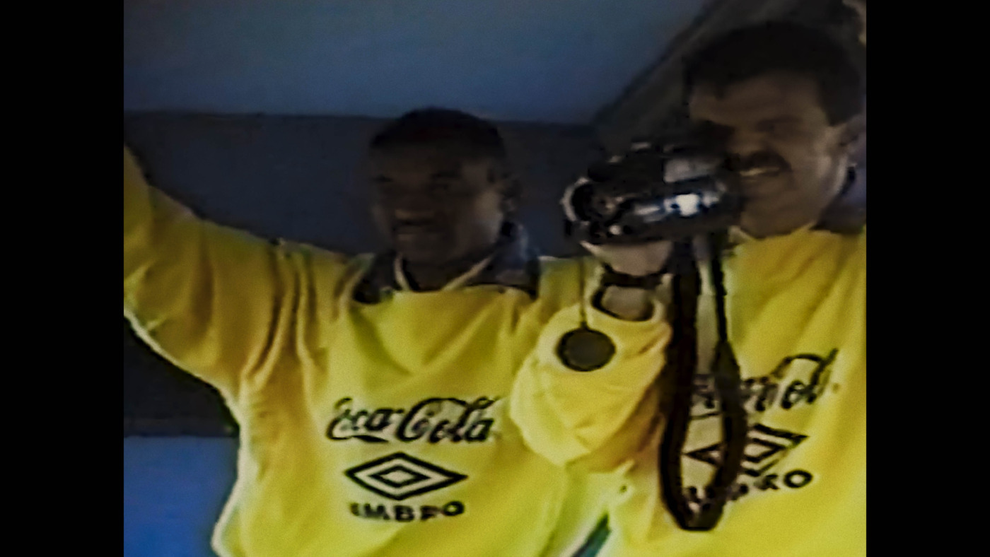 "Two teammates on Brazil's 1994 World Cup team capturing footage on a camcorder."
